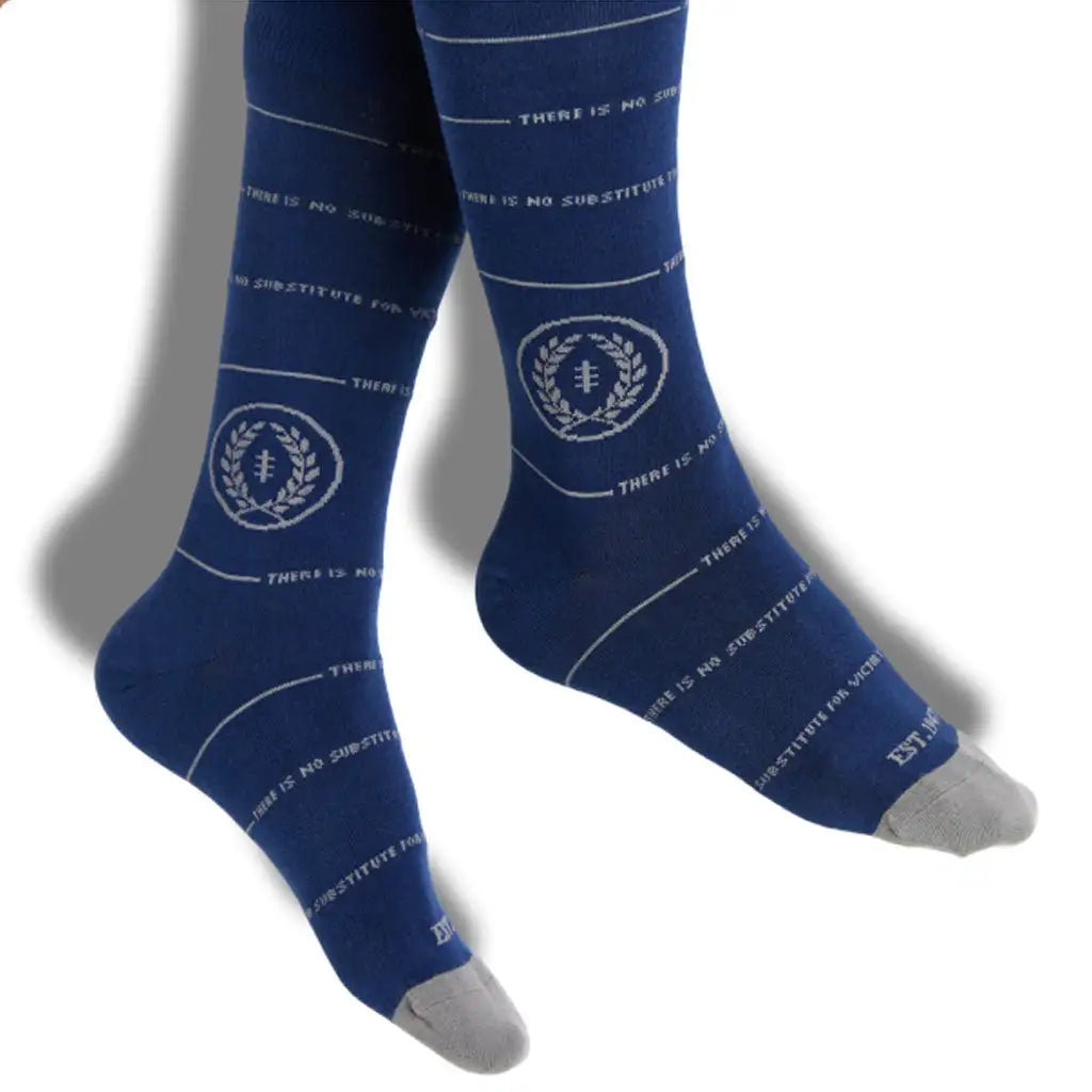 Deep blue crew socks with white text and a circular emblem featuring laurel wreaths, accented by gray toe caps.