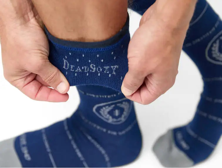 Deep navy blue deadsocks crew socks with white embroidered branding and a subtle dotted pattern.