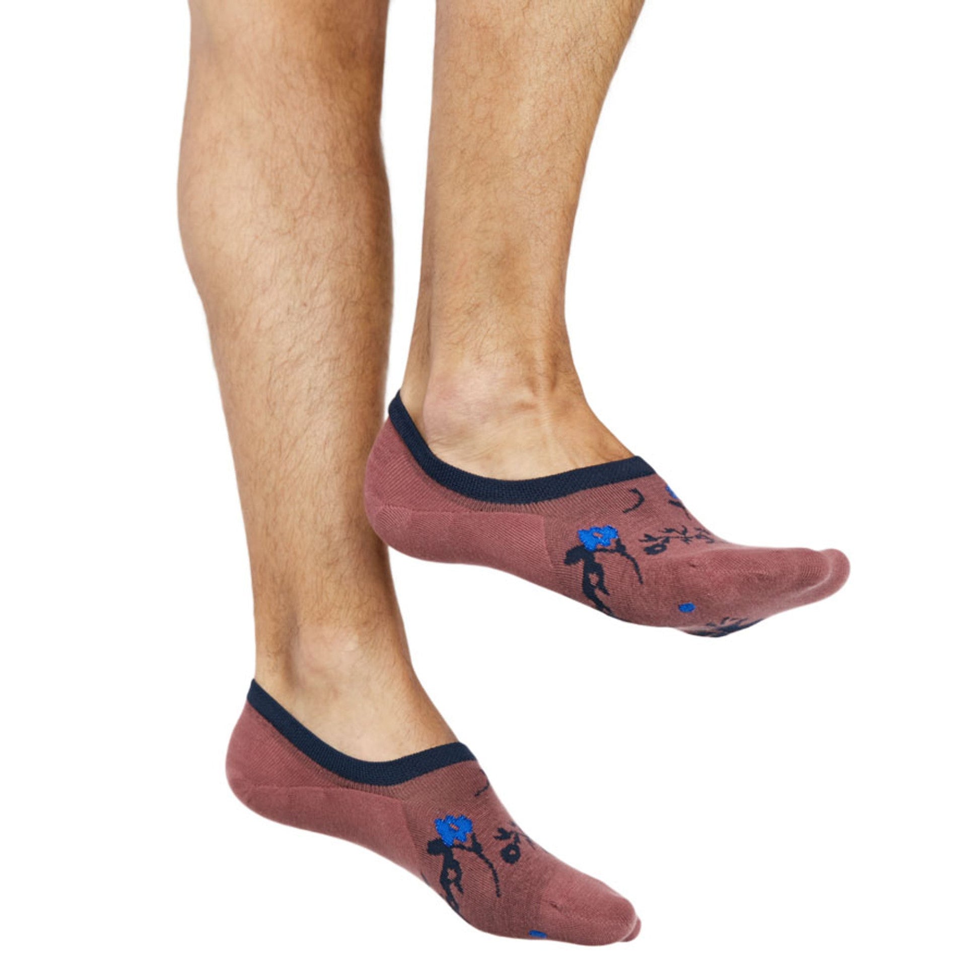 no show socks worn by male model solid rose color with a navy and powder blue floral design and navy welt