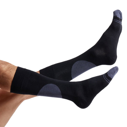 1 black dress sock with a large circle on the back of the leg and 2 charcoal accent stripes around the toe shown on legs coming into the image from the left
