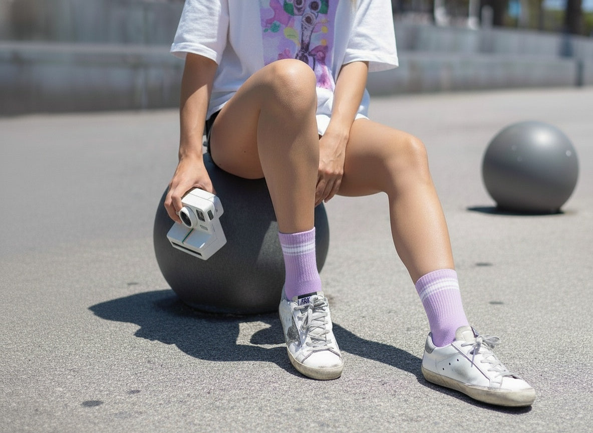 Lifestyle close-up of lilac quarter crew socks near camera.