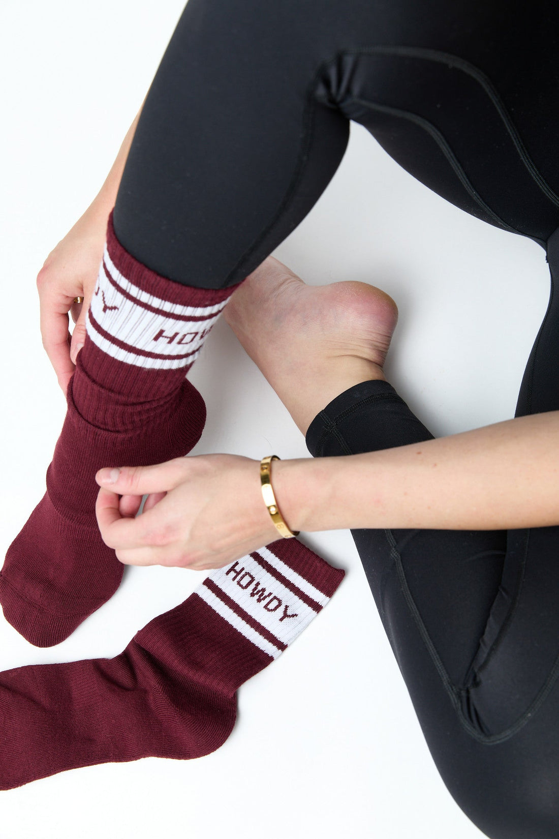 Maroon Retro Howdy Casual Crew Socks with vintage Howdy design adjusting the socks