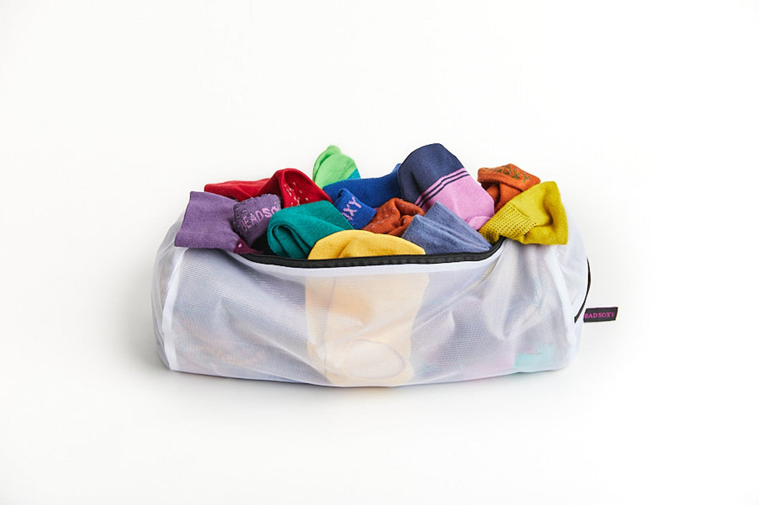 New and Improved sock wash bag full of DeadSoxy premium super soft seamless socks.