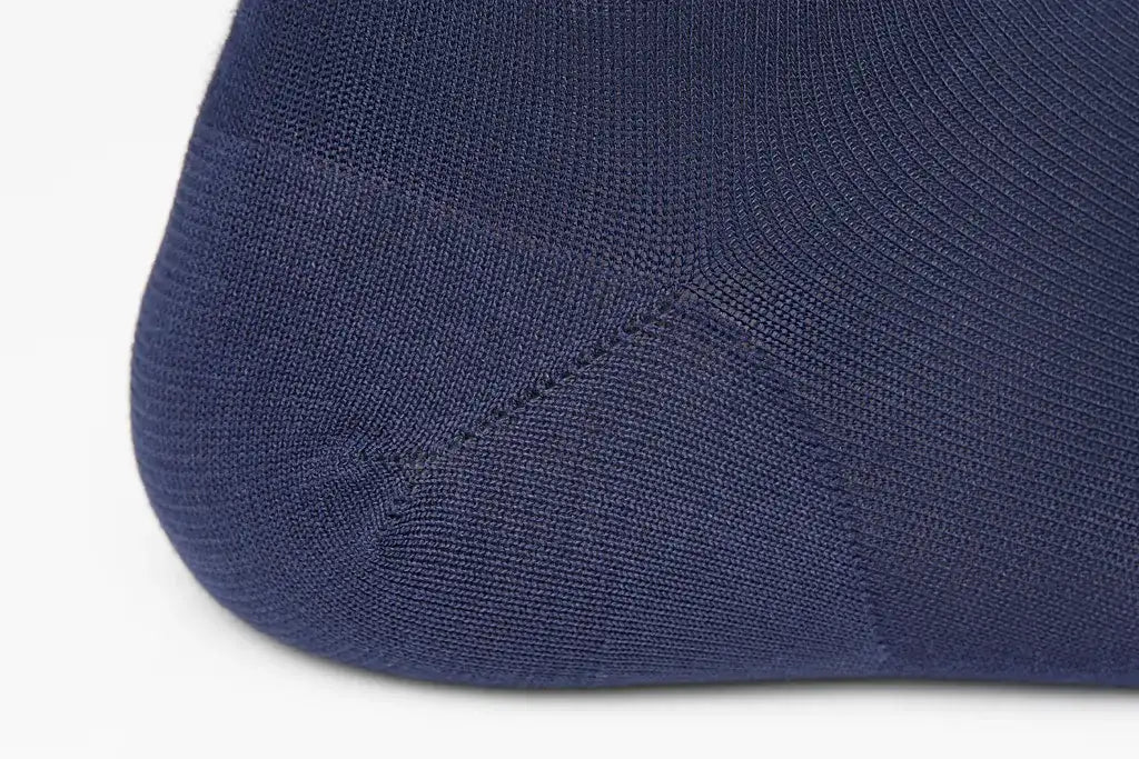 Navy blue knit ankle sock with a smooth, seamless design