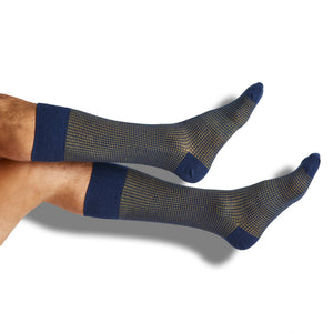 Navy and gold birdseye dress socks shown on legs