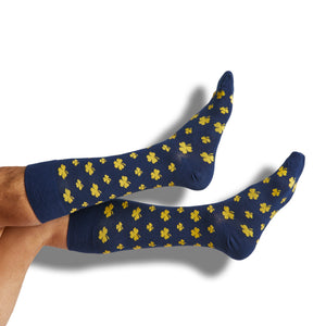 Navy dress socks with gold shamrocks design shown on legs