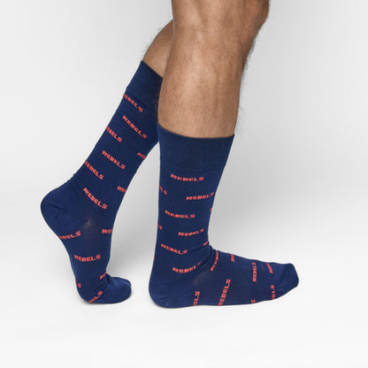 Navy dress socks with REBELS in text in an all over pattern on male legs
