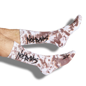 Not.Travis casual collab socks with brown tie dye design shown on legs.