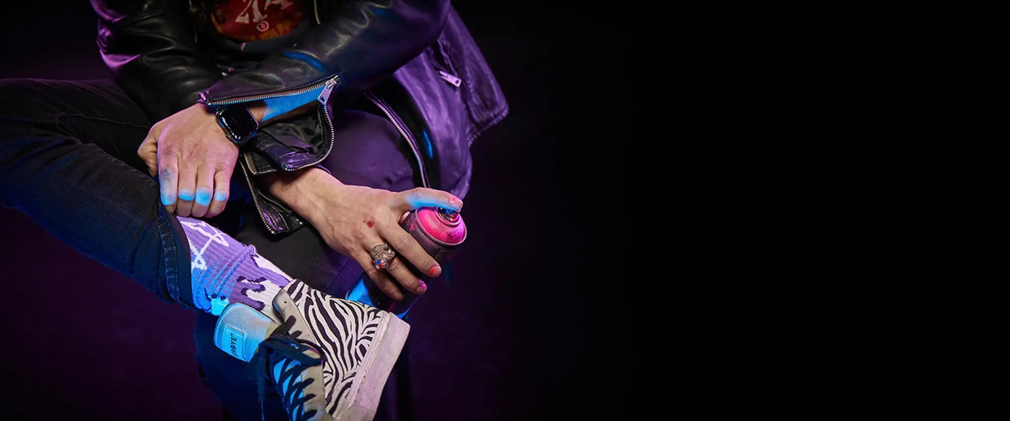 Pink spray paint can with a silver nozzle and black cap.