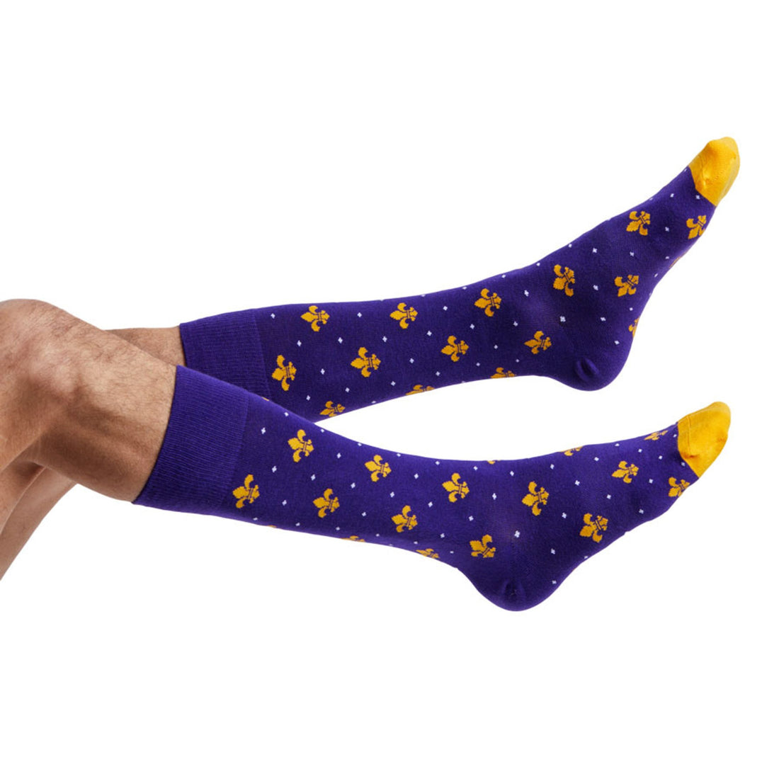 purple dress socks with gold fleur de lis and gold toe on legs coming into the image from the left