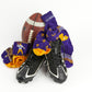 Purple and gold dress socks sitting with a football and cleats.