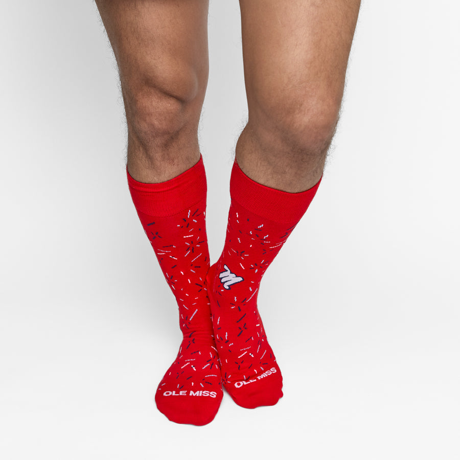 Red socks with a pattern and 'OLE MISS' branding on a white background