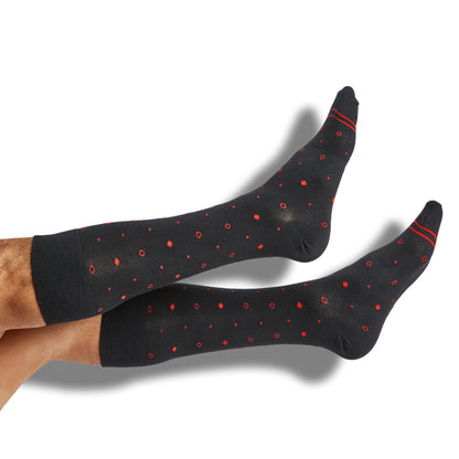 Black dress socks with red dot and circle design shown on legs