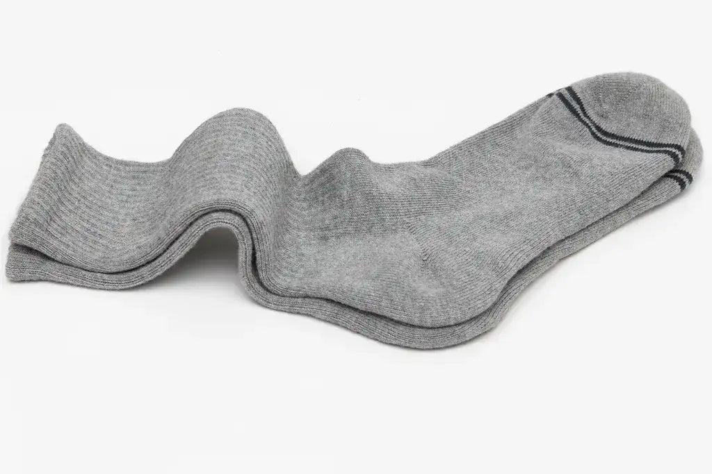 A single gray sock with a ribbed texture and black trim along the toe.