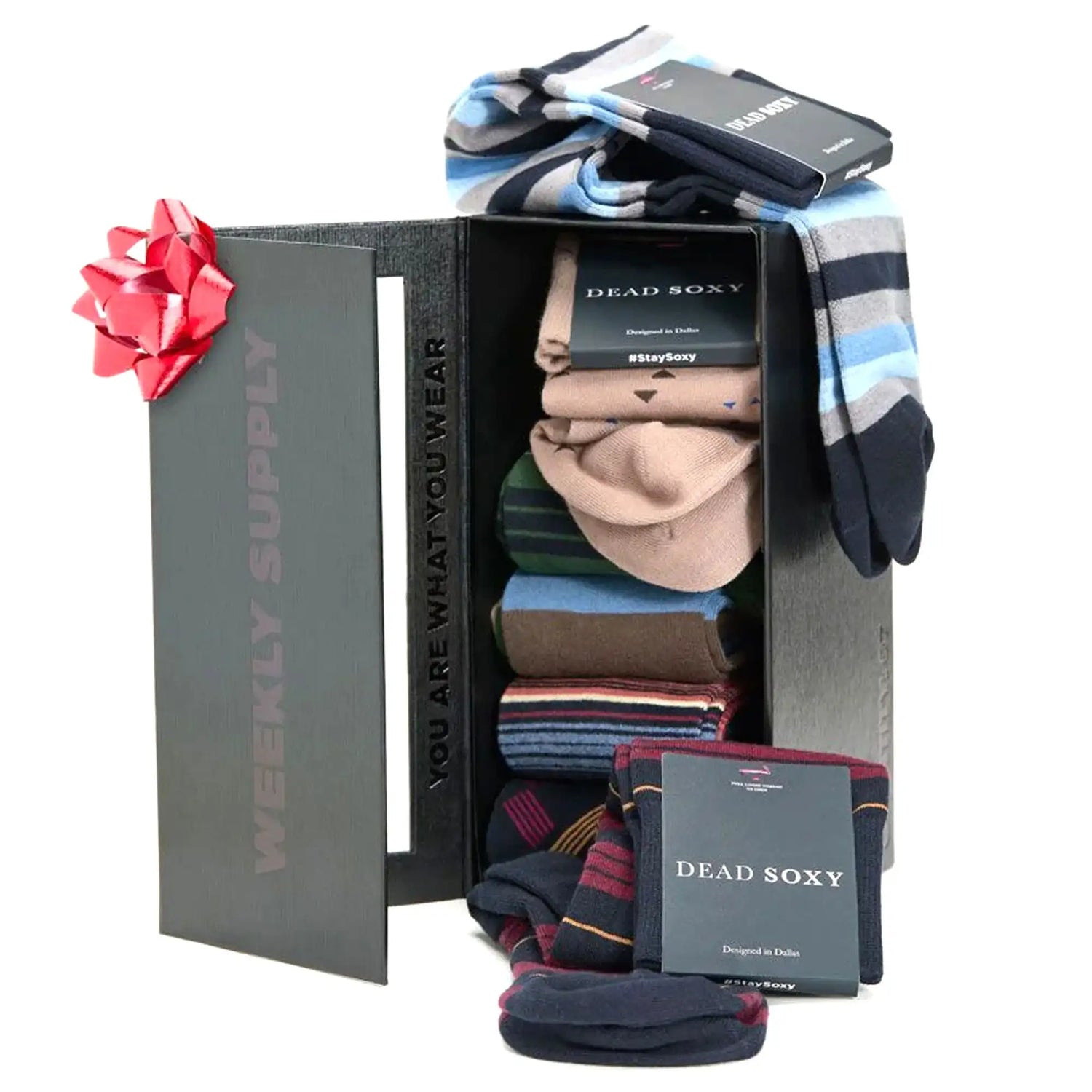 A sleek black gift box with a red bow, containing neatly arranged pairs of dead soxy socks in various patterns and colors.