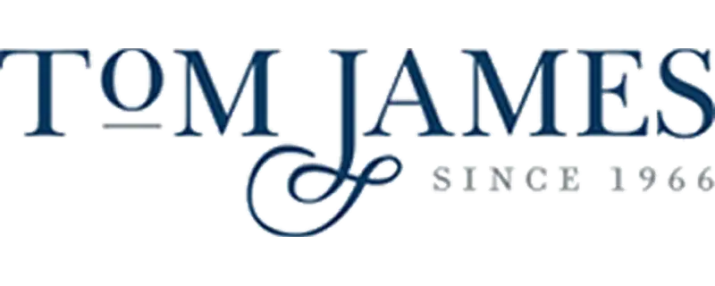 Tom james logo in elegant blue serif font with a decorative flourish beneath the name.