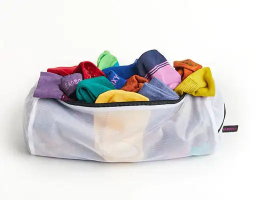 Transparent mesh laundry bag filled with colorful socks.