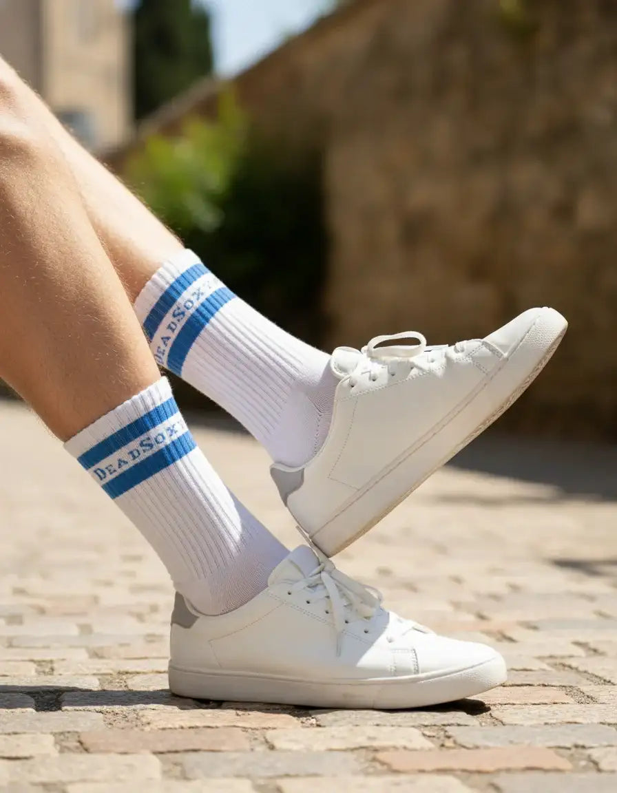 White dead sox socks with blue stripes and branding, worn with white sneakers.