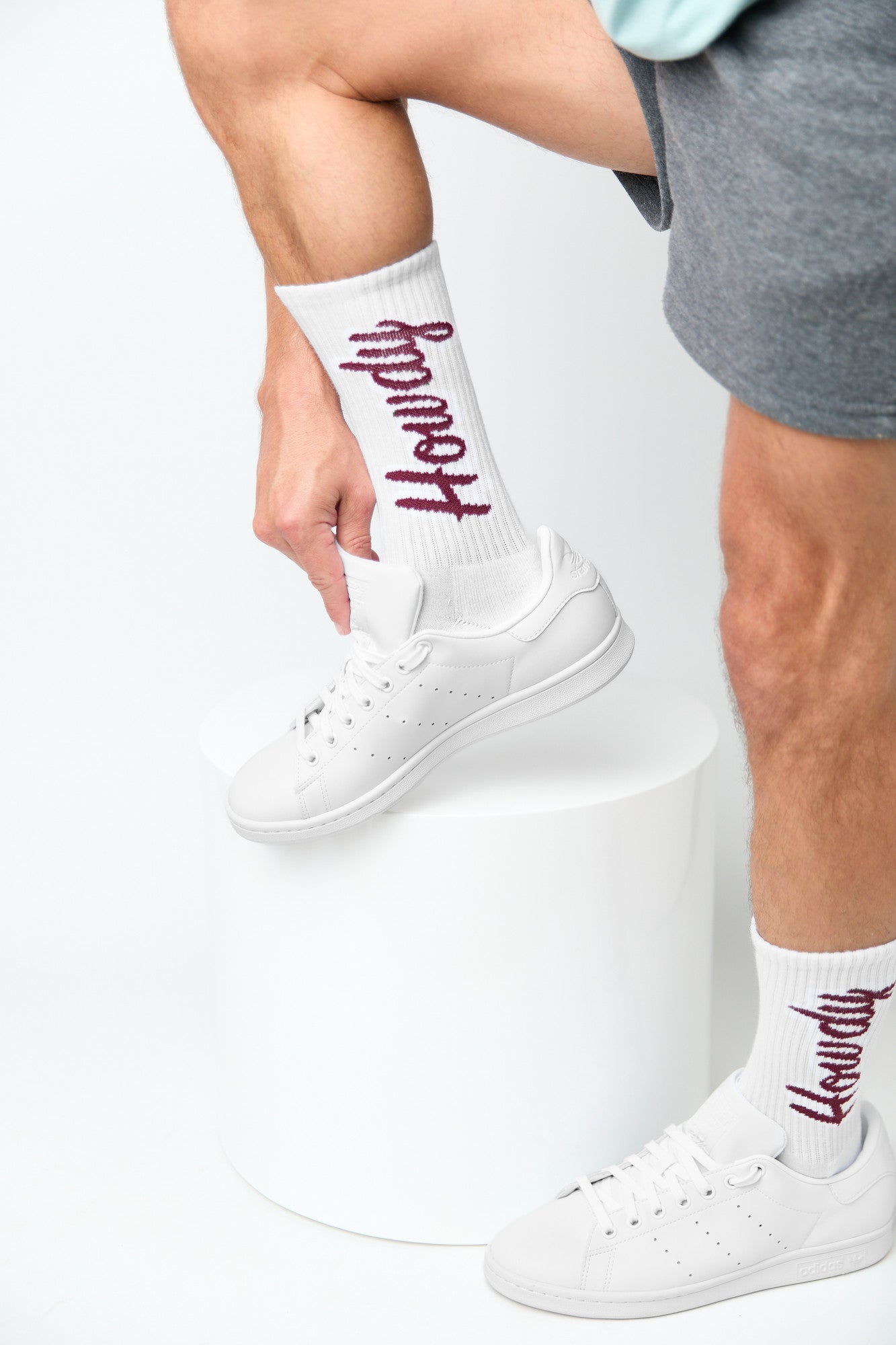 White Howdy Casual Socks with 'Howdy' text going up the leg in maroon. on mannequin.