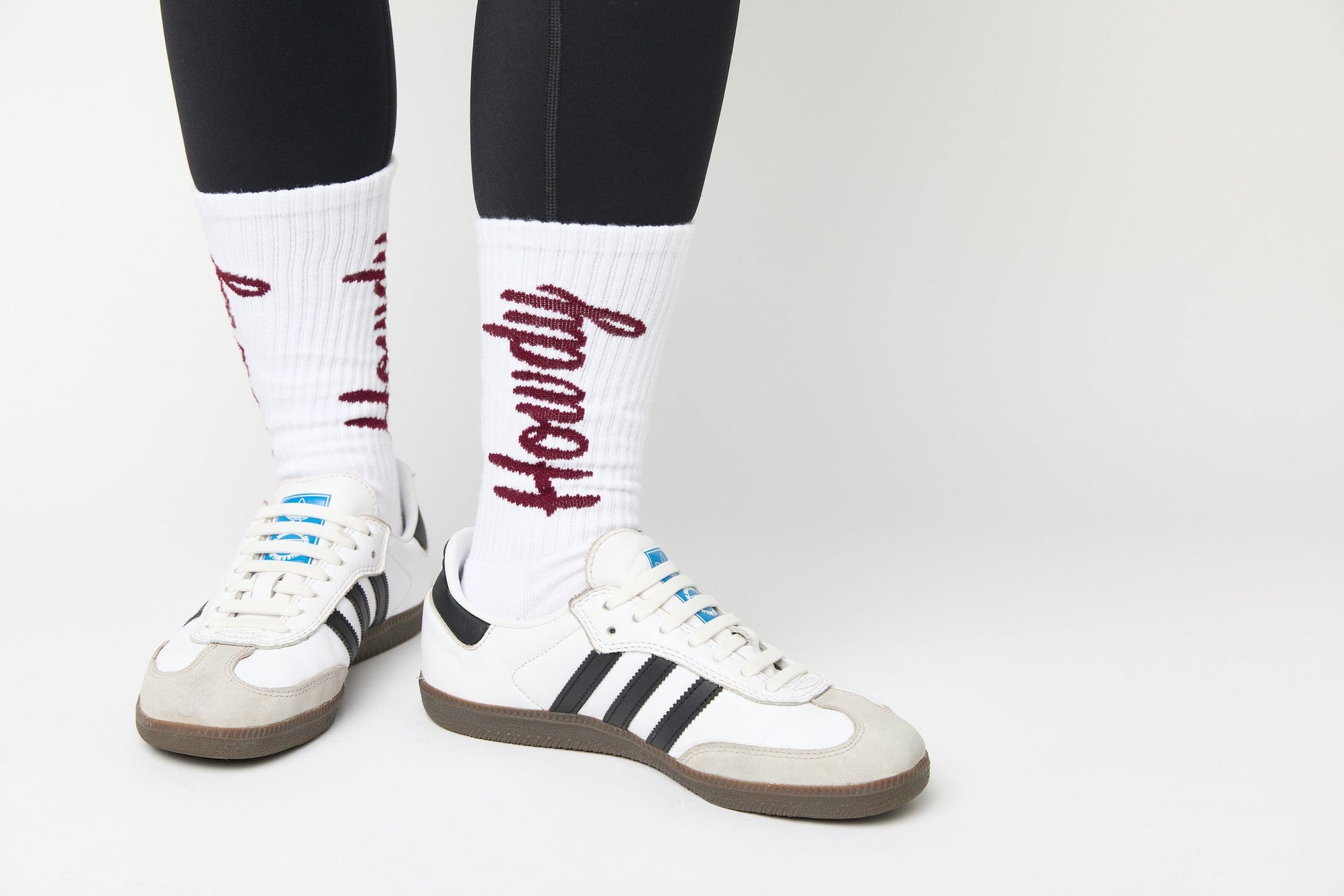 white casual crew socks with cushion and Howdy going up the leg on a woman in black leggings