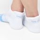 White and powder blue 50/50 ankle socks with two accent stripes around the toe.