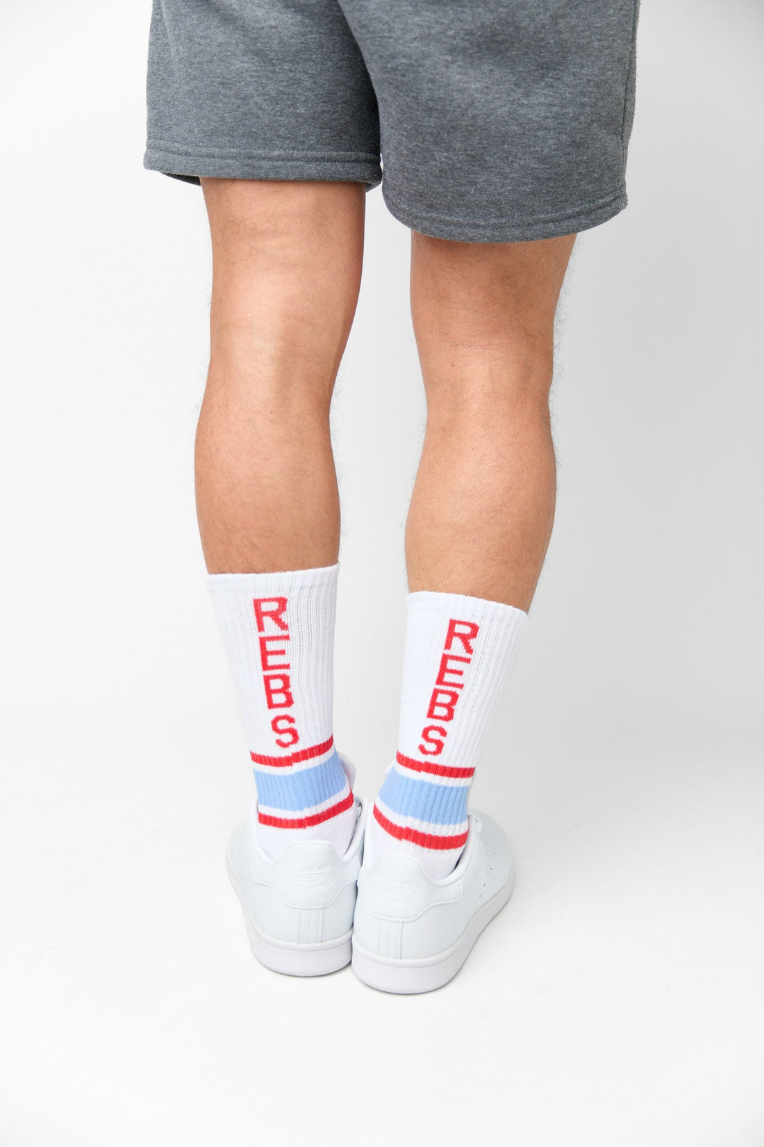White crew socks with stripes on the ankles and ' REBS ' down the back of the leg.