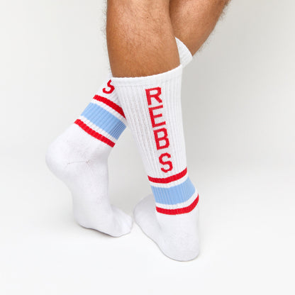 White Casual Crew Socks with 'Rebs' down the back of the leg retro stripes on the ankle in powder and red.